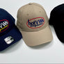 Three baseball caps displayed side by side on a light gray background: a navy blue cap, a beige cap, and a black cap. Each cap features an embroidered oval logo reading 'hotVWs magazine' in white, red, and yellow.