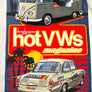 A close-up of a graphic print on a white fabric background. The print features retro illustrations of classic Volkswagen vans and cars with bold text reading 'dune buggies and hot VWs magazine' over a red, yellow, and blue tropical sunset design.